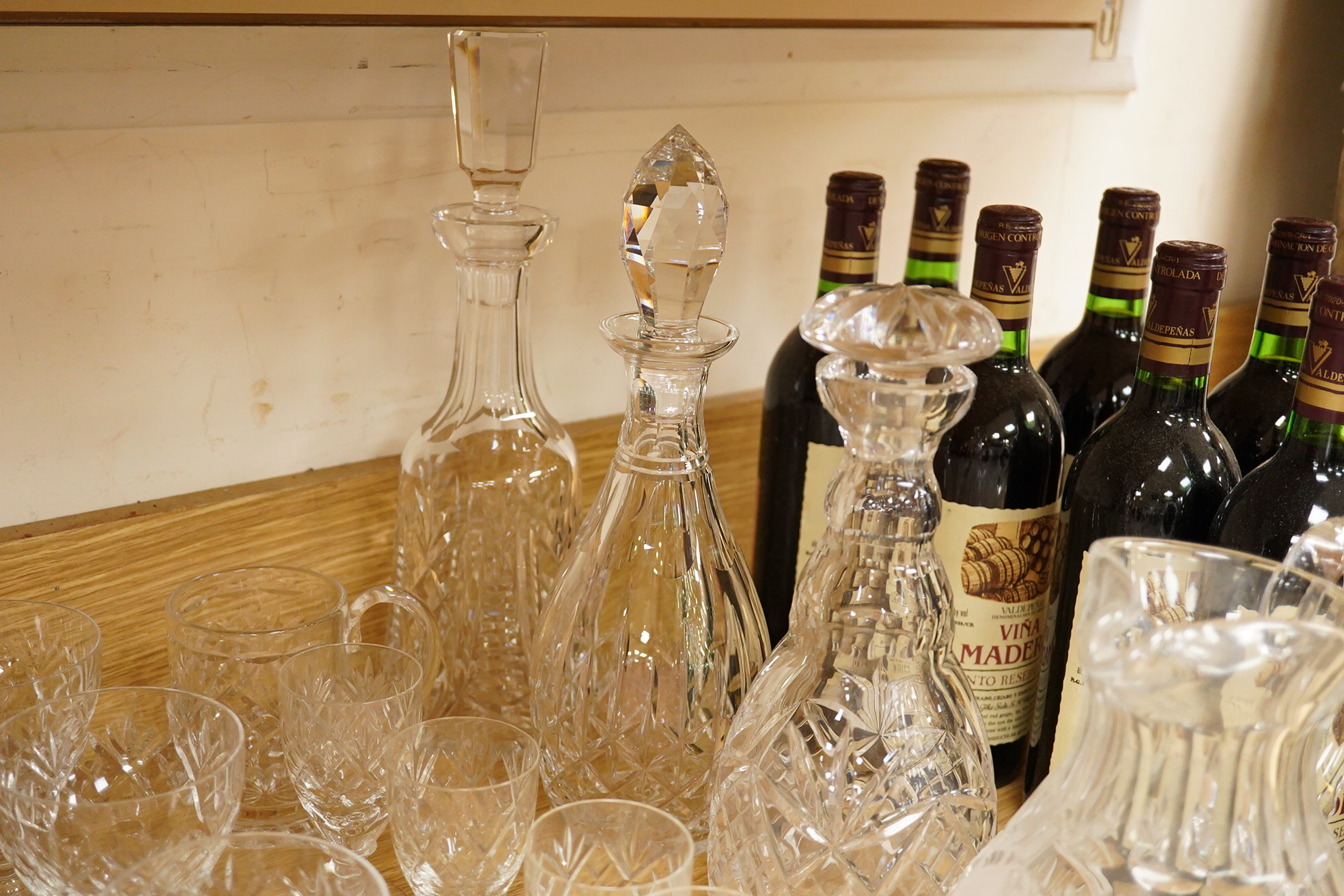 A collection of Webb cut glass suites and four decanters, together with a glass jug, largest 35cm high